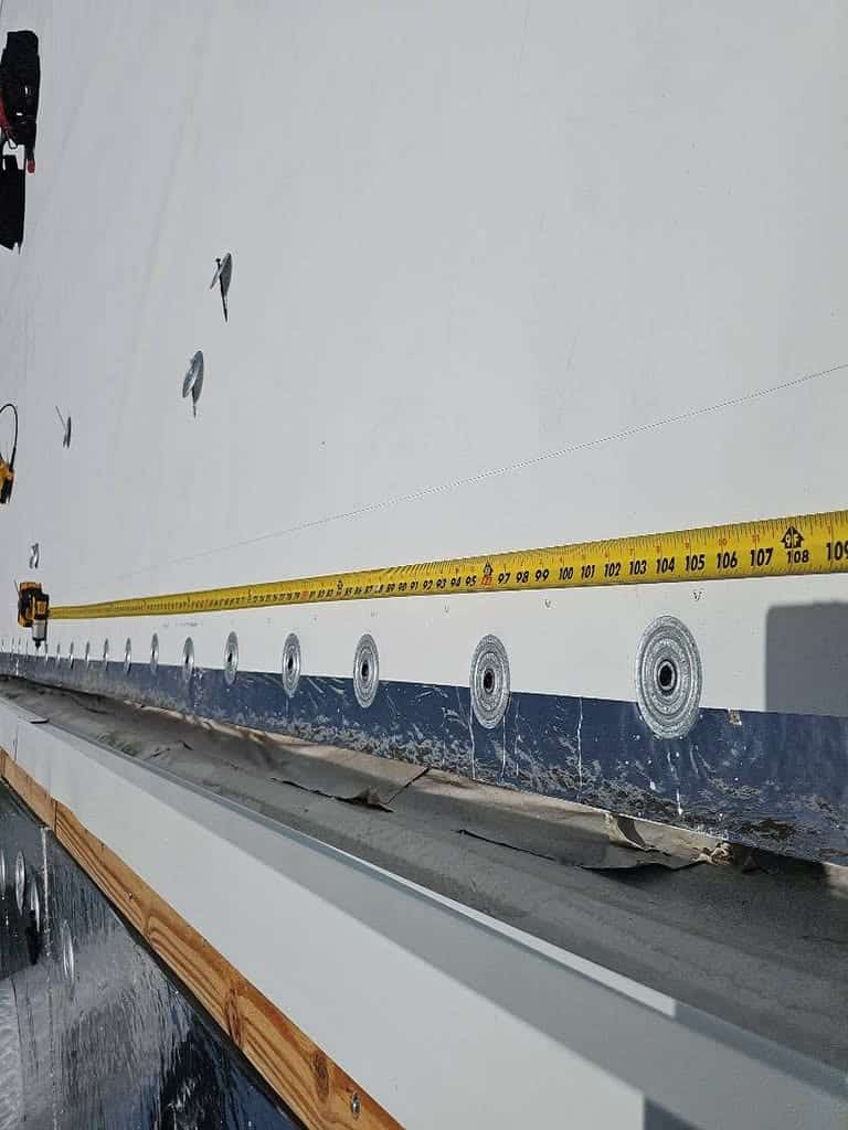 TPO membrane being laid over insulation board