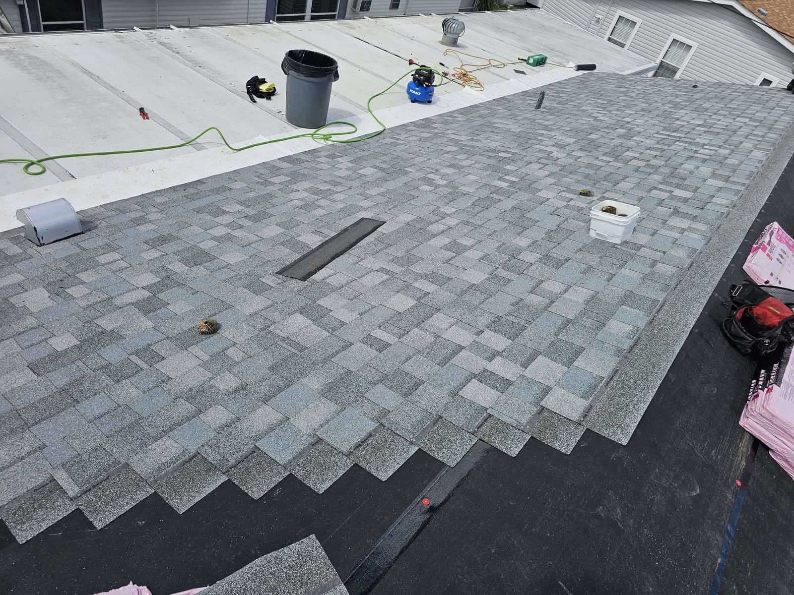 Architectural asphalt shingles installed in staggered courses over the new underlayment