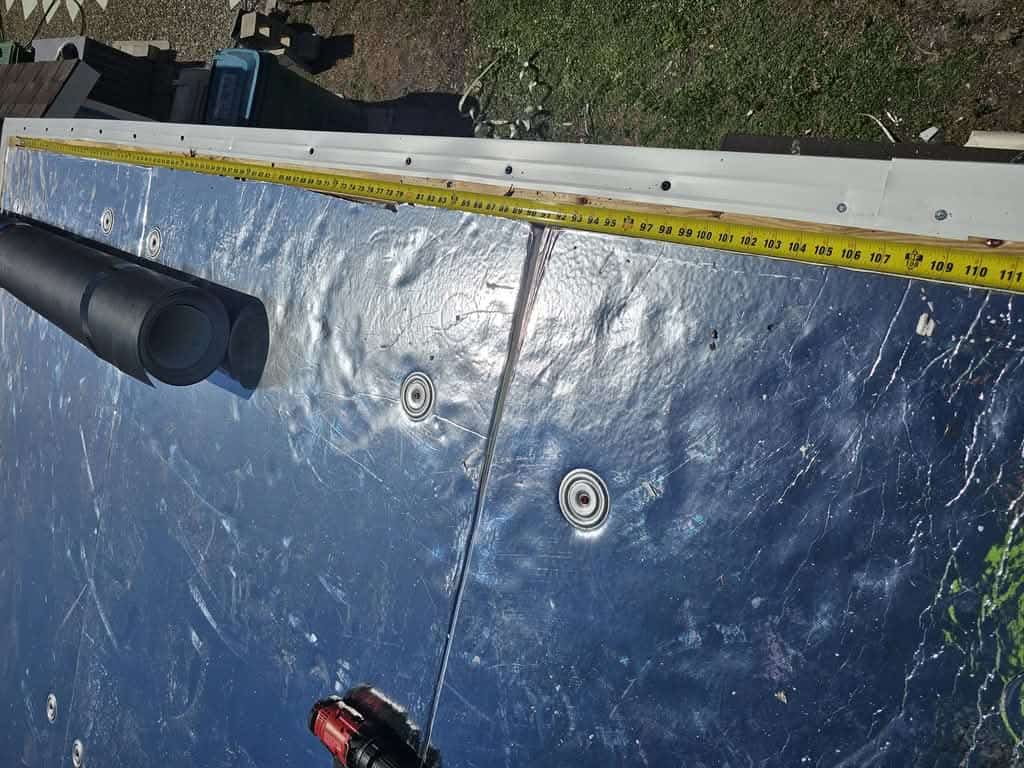 Foil-faced insulation board fastened with plates before TPO membrane